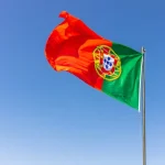 Beautiful shot of the Portuguese flag waving in the calm bright sky